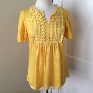 Bright yellow flowy top